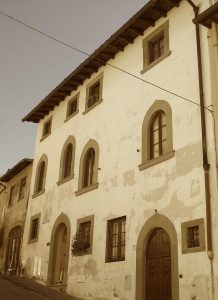Facade of large house on Costa San Georgio with arched windows and doors.