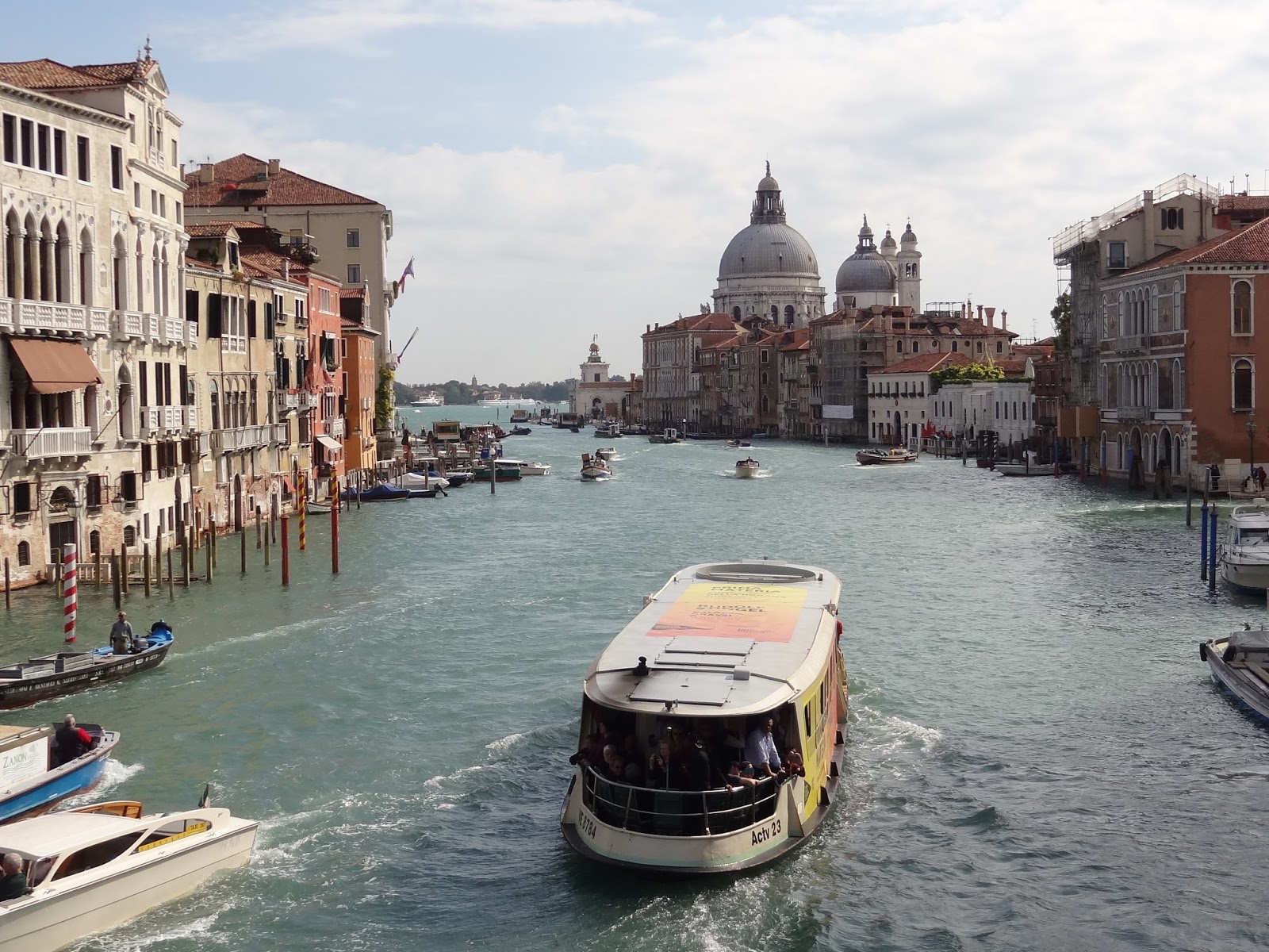 view of Venice Grand canal with large water taxi and St. Mark's Basilica in distances