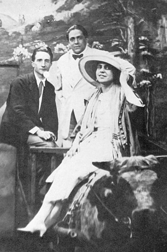 Duchamp, Picabia, and Wood posing in landscape mural, with Wood seated on an ox.