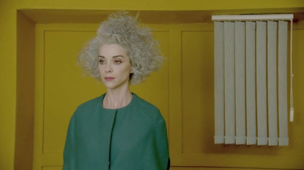 screenshot of woman in yellow room from St. Vincent video