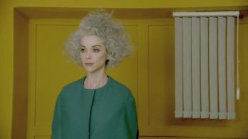 screenshot of woman in yellow room from St. Vincent video