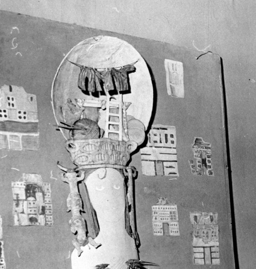 Construction of female bust with large architectural headdress.