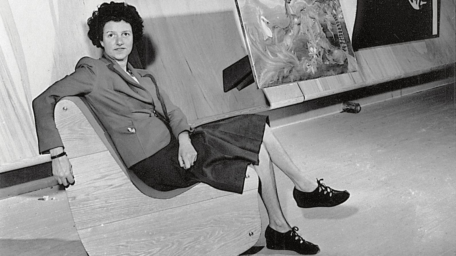 Guggenheim seated in gallery in front of abstract painting