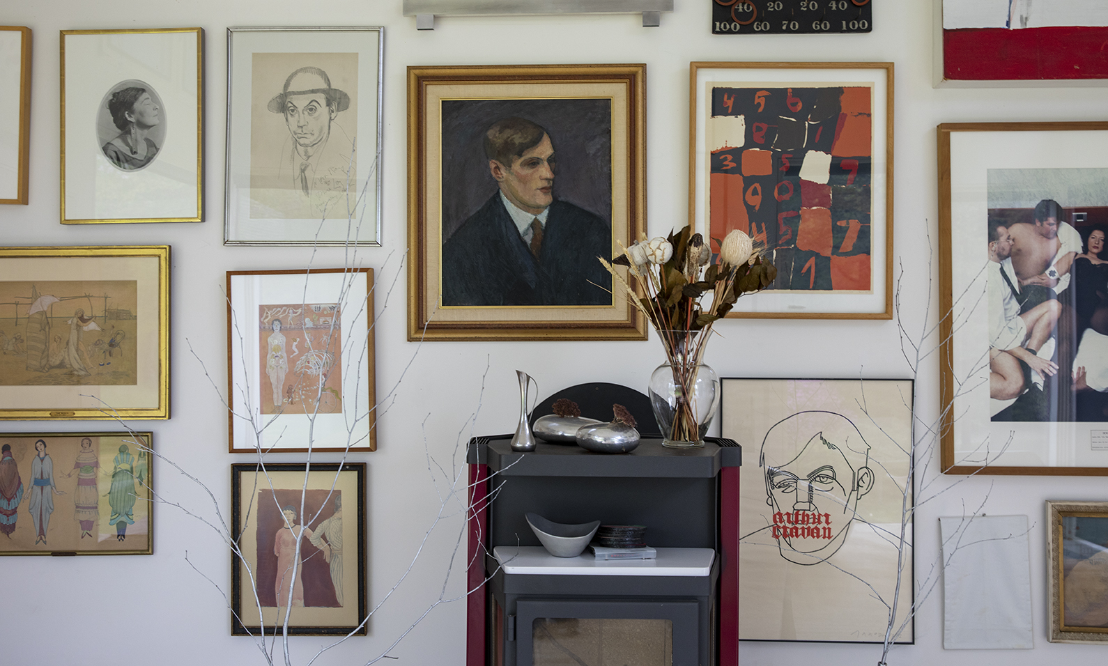 interior wall of Conover's home, containing paintings and portraits by Loy and other avant-garde artists, hung salon style.