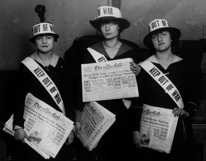 Day and two other women holding copies of The Call newspaper and wearing hats and ribbons saying "Keep out of war."